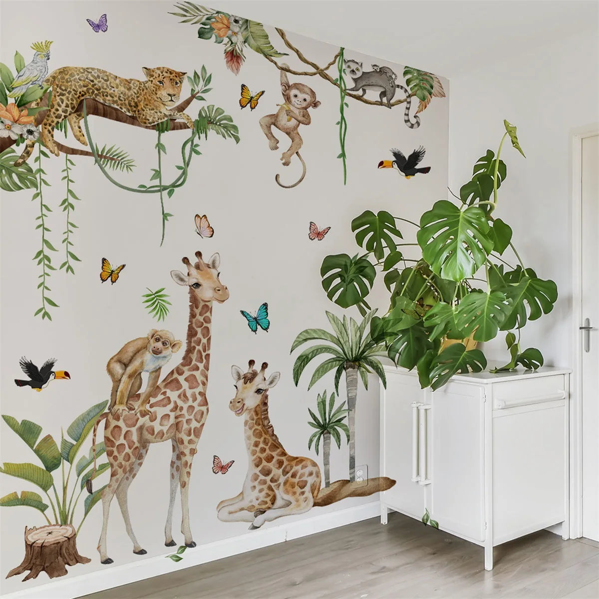 Woodland Animal Wall Decals featuring playful giraffes, monkeys, and a leopard in a vibrant nursery setting.